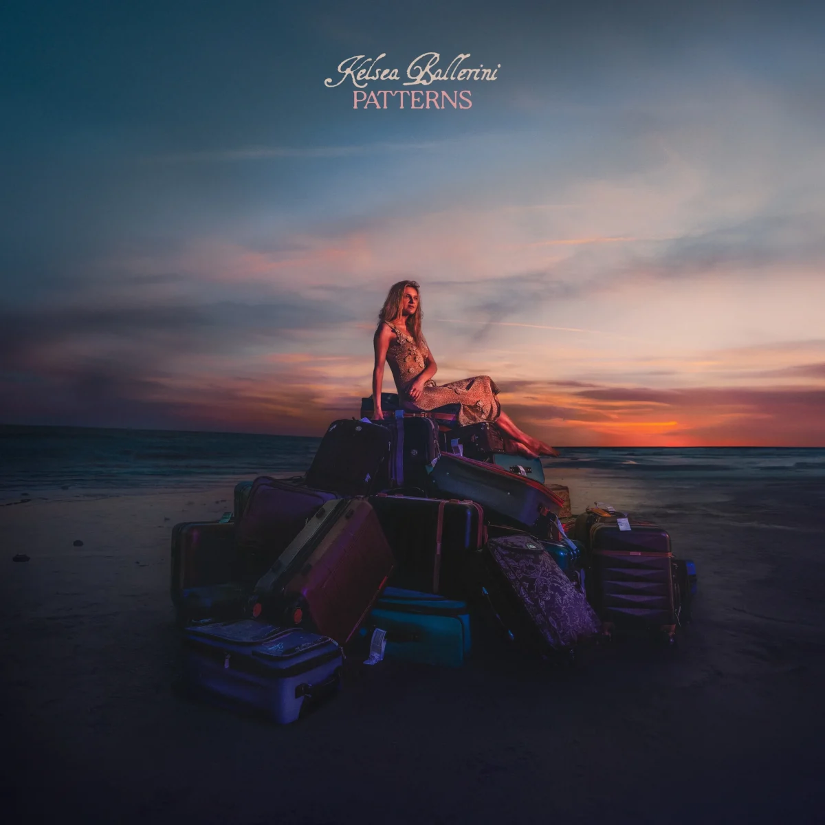 On the PATTERNS album cover, Ballerini rests on a pile of suitcases with a coastal background, symbolizing lyrics from her third track titled “Baggage.” (Promotional courtesy of Nyk Allen and Black River Entertainment)
