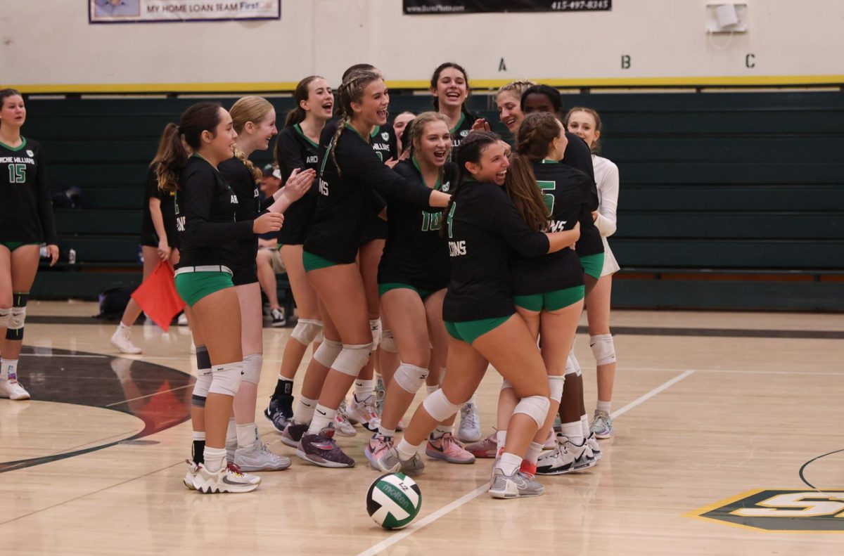 Archie Williams celebrates sophomore Sadie Weinberg on her set-winning ace.