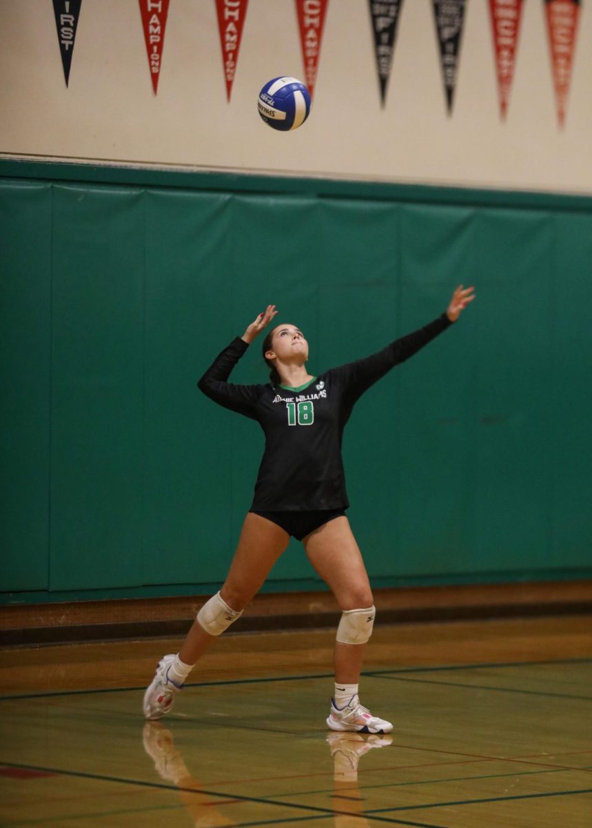 Senior Sadie Smith serves the ball leading to a point during the second set of the game.