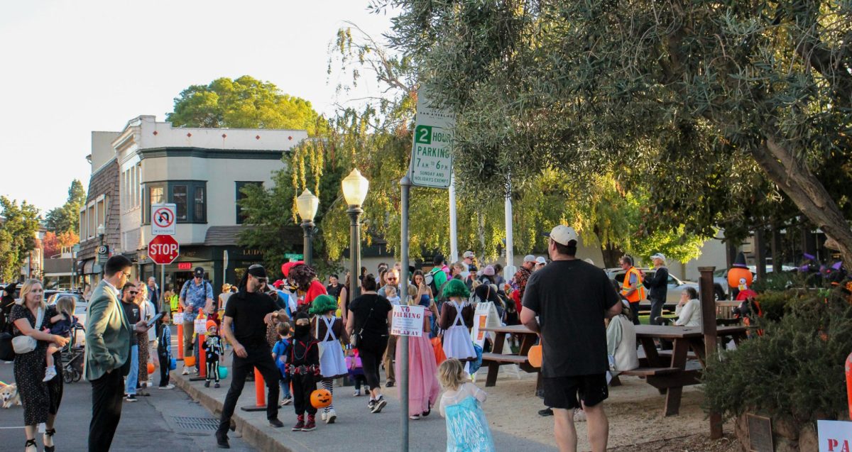 Trick-or-treaters gather in front of San Anselmo Town Hall collecting candy. 