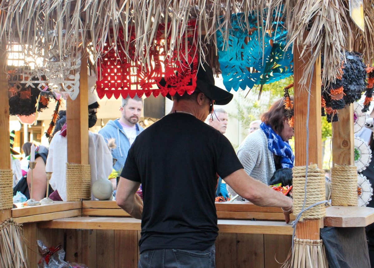 Kids line up for treats in front of the colorfully decorated tiki bar. 