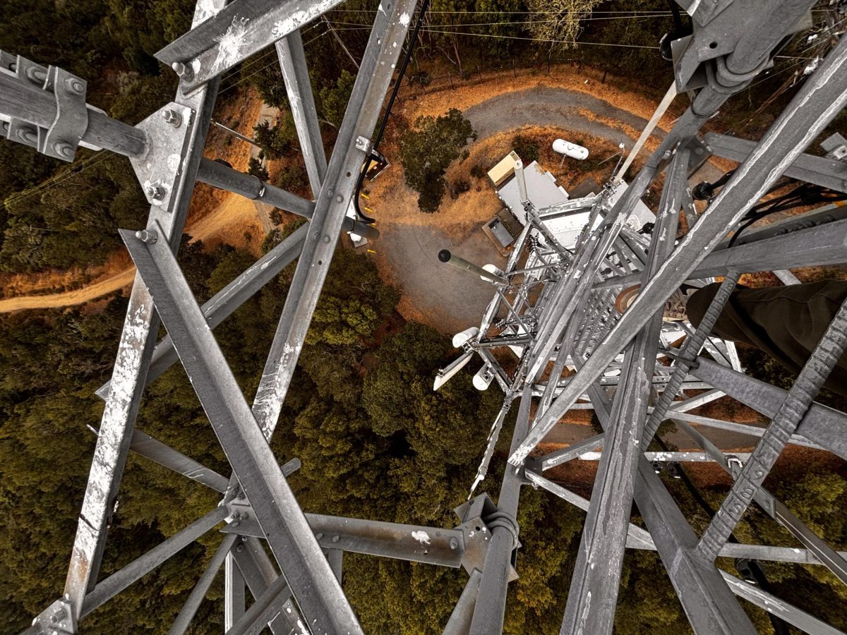 An urban explorer navigates the beams of a tall radio tower. (Image courtesy of Justin)