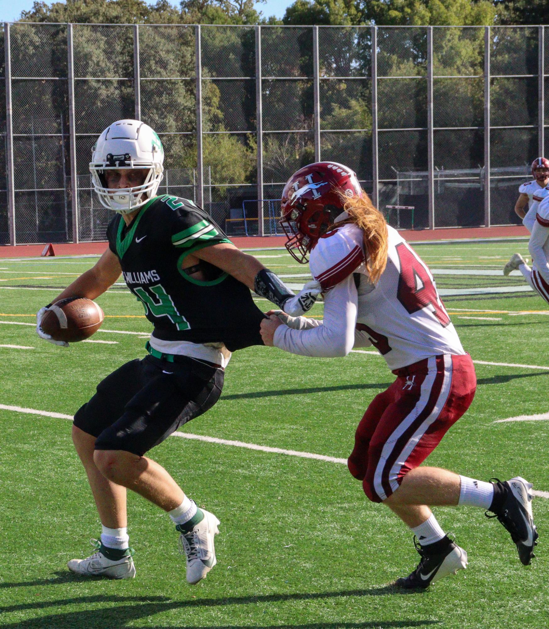 Healdsburg defensive player attempts to tackle Archie Williams senior Isaac Pierce.