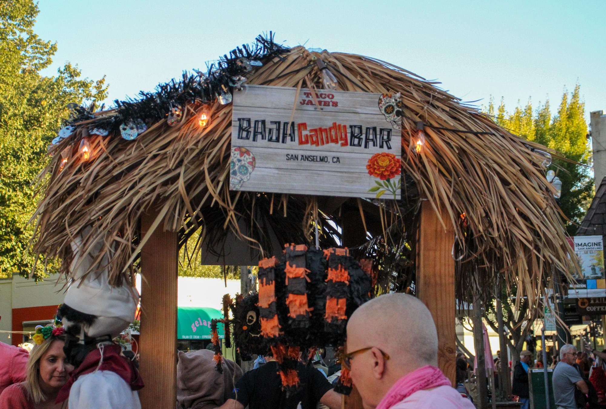 A volunteer-run candy bar passes out trinkets and sweets across from Creekside Pizza. 