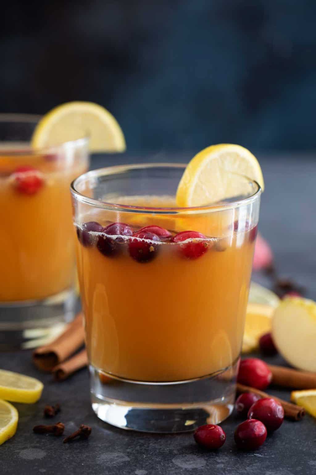 Sweet apple cider topped off with cranberries and a slice of lemon. (Courtesy of tasteandtellblog.com)