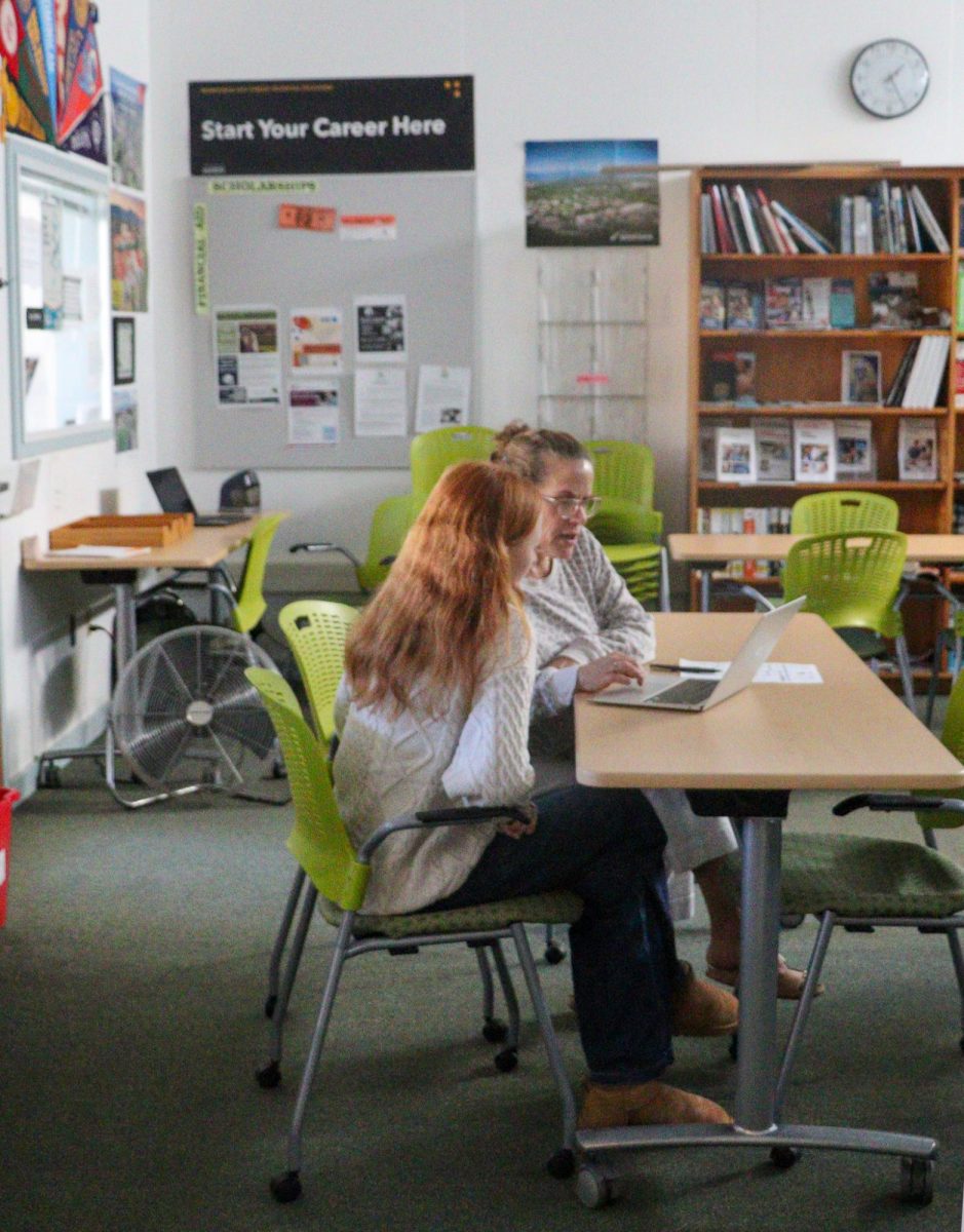 Lisa Neumaier assists a student in the College and Career center.