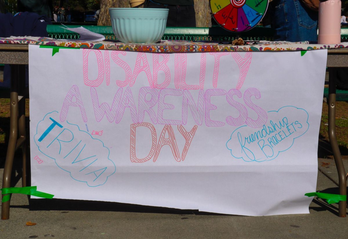 Disability Awareness Day sign hangs on the event table.