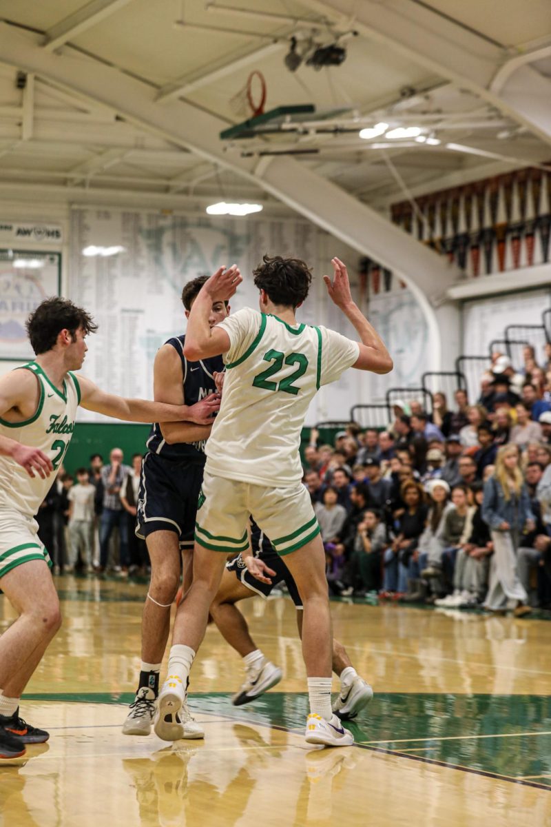 Junior Alex Hamblet keeps his hands up to avoid getting a foul.