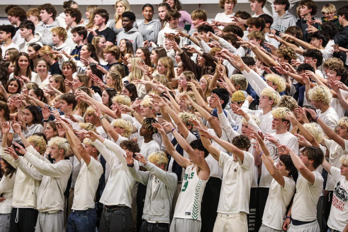 The Archie Williams student section does "spirit fingers" in hopes of a basket. 