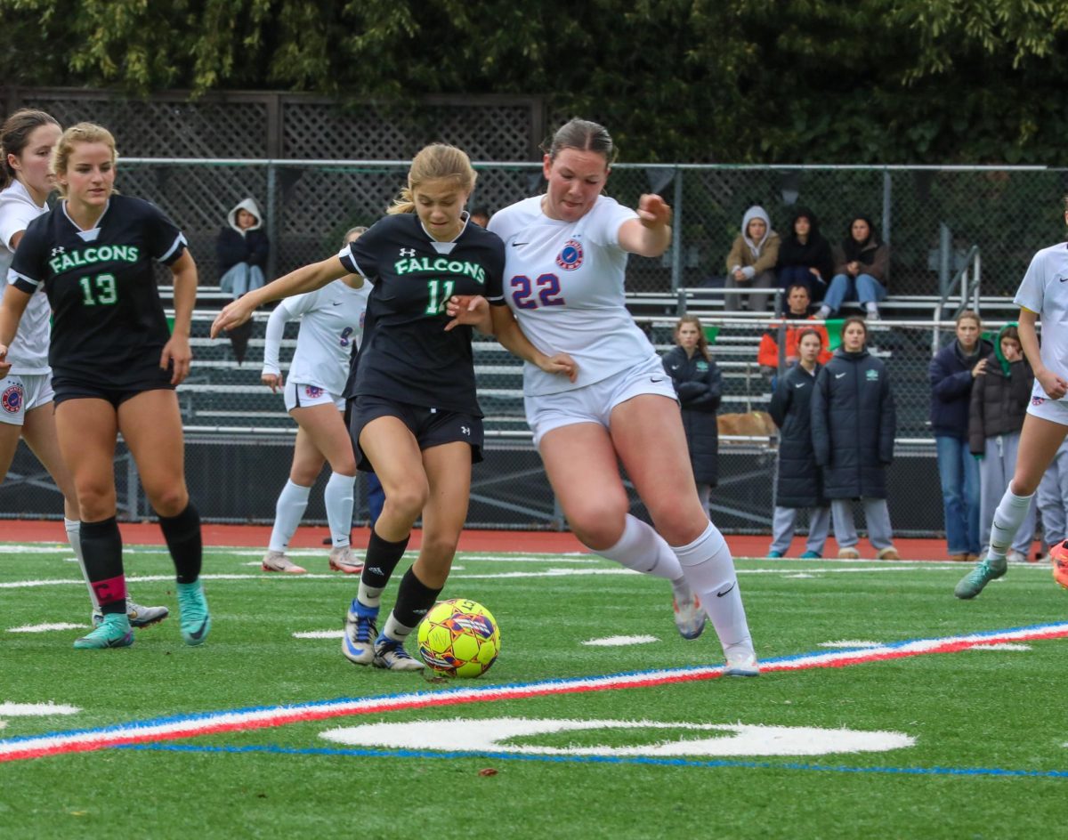 Junior midfielder Leta Benson attempts to win possession against a Tam defender.