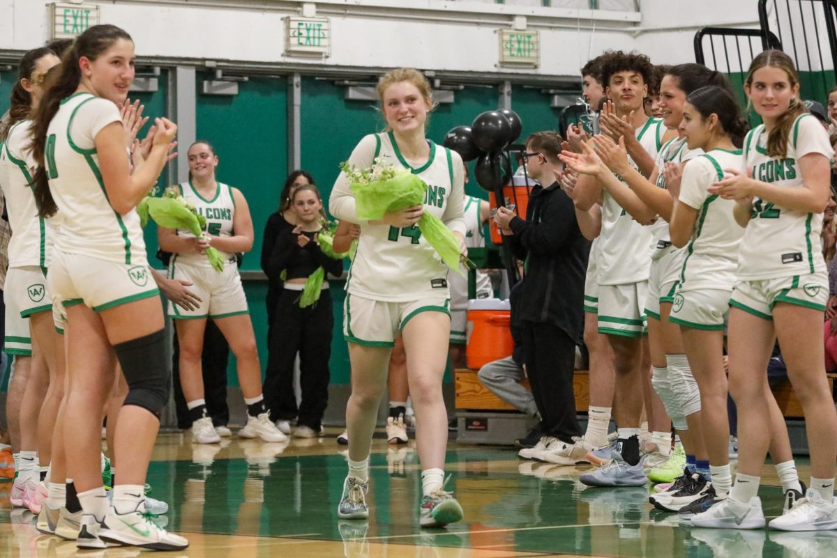 Archie Williams senior Carolyn Morris receives flowers during the senior night ceremony. 
