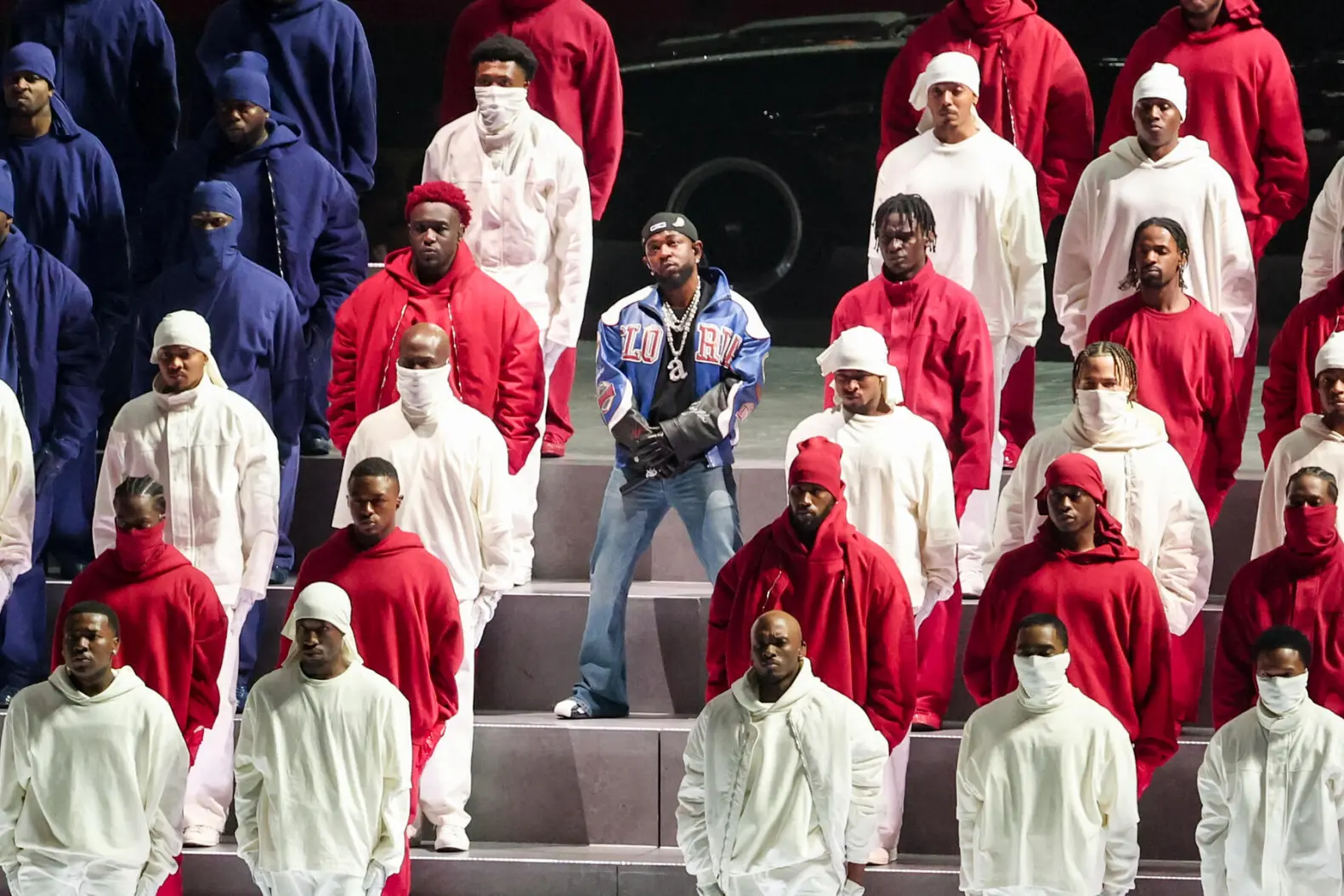 Super Bowl halftime performer Kendrick Lamar strikes a pose surrounded by dozens of patriotically clad backup dancers. (Courtesy of Rolling Stone)