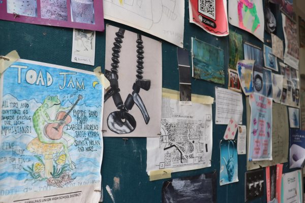 Ceramics class bulletin board displays student art, as well as posters highlighting current events. 