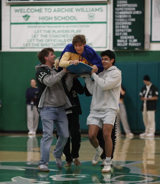 "Captain Condom" gets flown out on a surfboard to talk about consent for the upcoming dance.