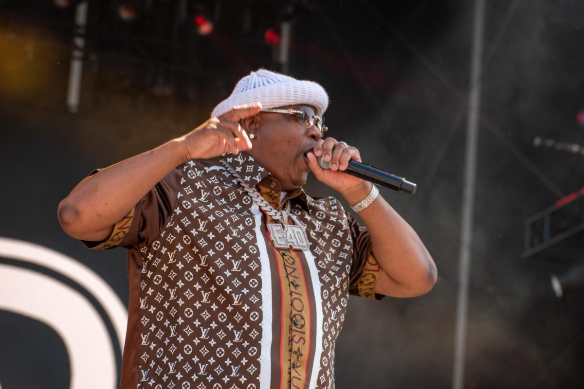 Rapper E-40 walks down the stage's catwalk singing to the crowd.