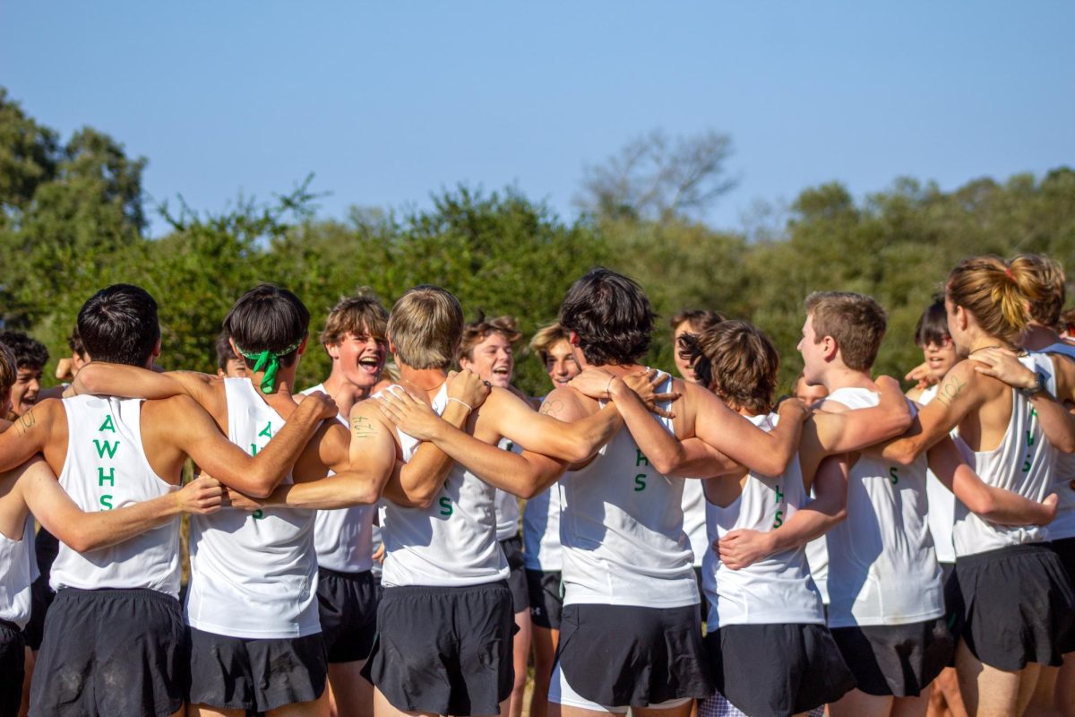 Archie Williams' 2022-23 Cross Country team forms a huddle before their race.