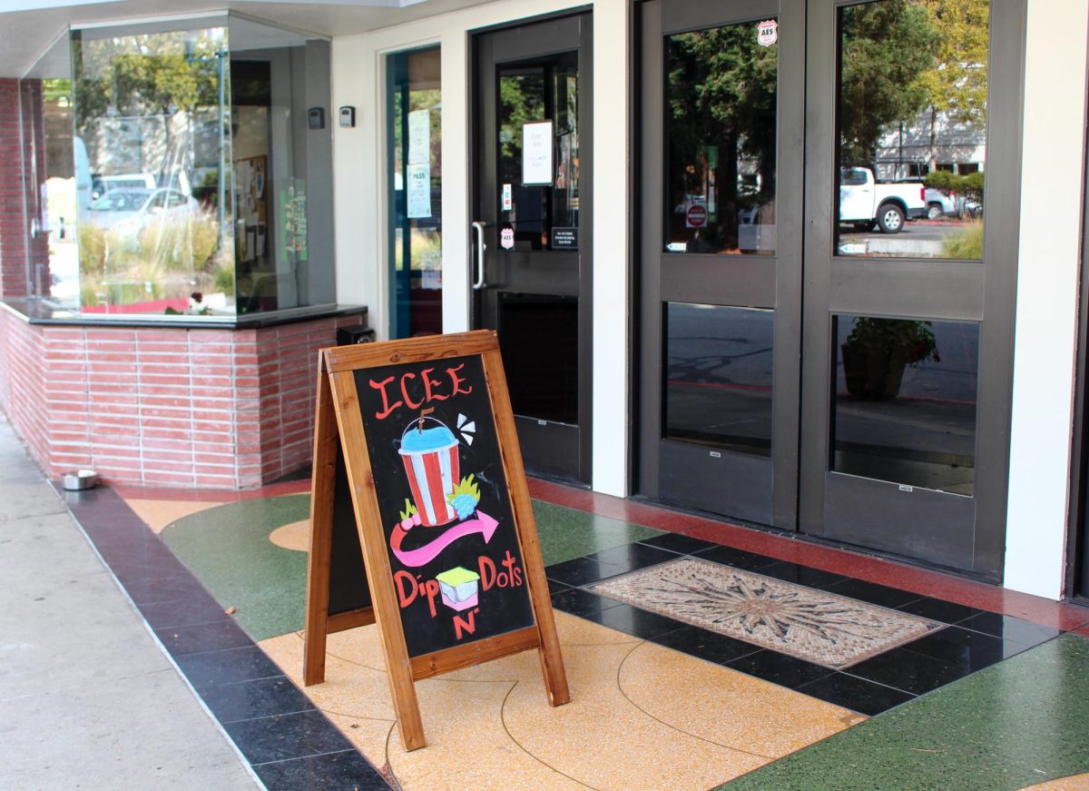 A sign in front of the Fairfax Theater advertises new treats for sale.