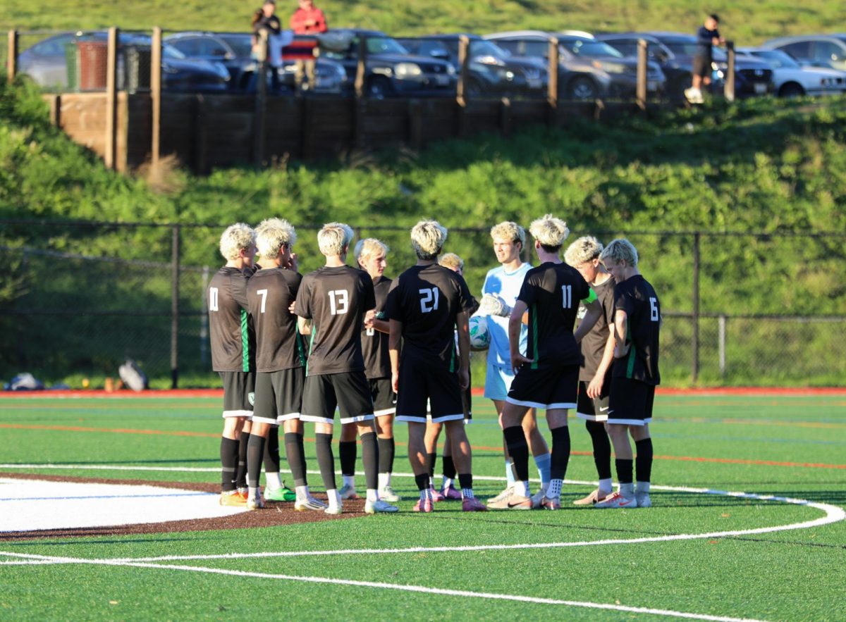 The Falcons gather together after injury timeout to discuss strategy.