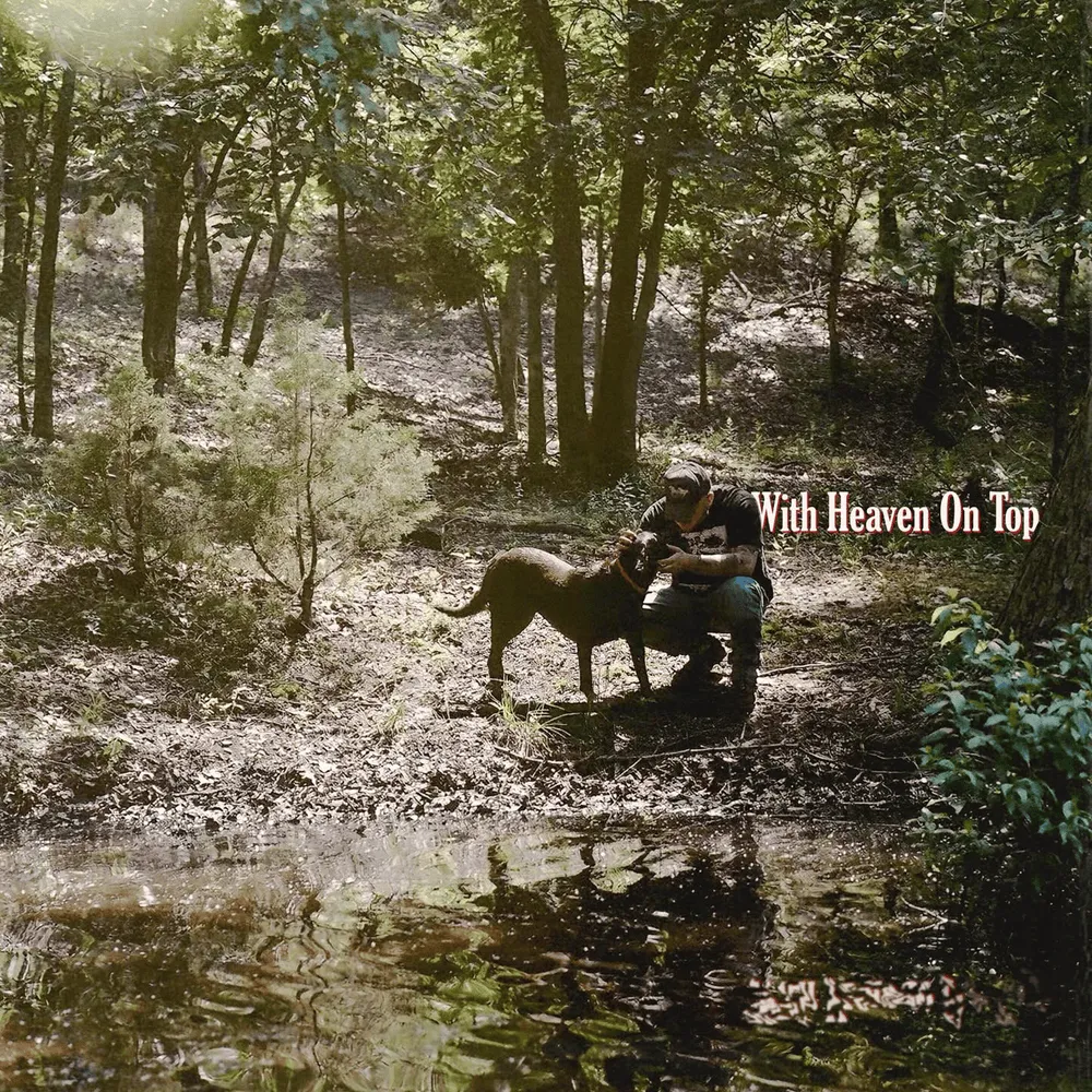 Zach Bryan with his Labrador, Jack, on the cover of With Heaven on Top. 