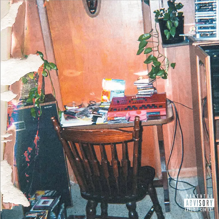 J. Cole's newest album The Fall Off features a grainy image of a cluttered dark wood desk.
