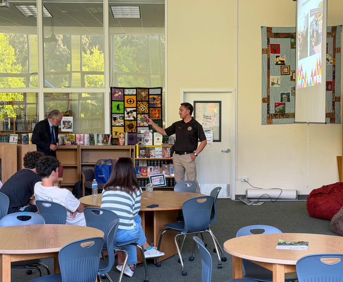California Highway Patrol Officer Arthur Tellez presents safe driving advice in the Archie Williams library. 
